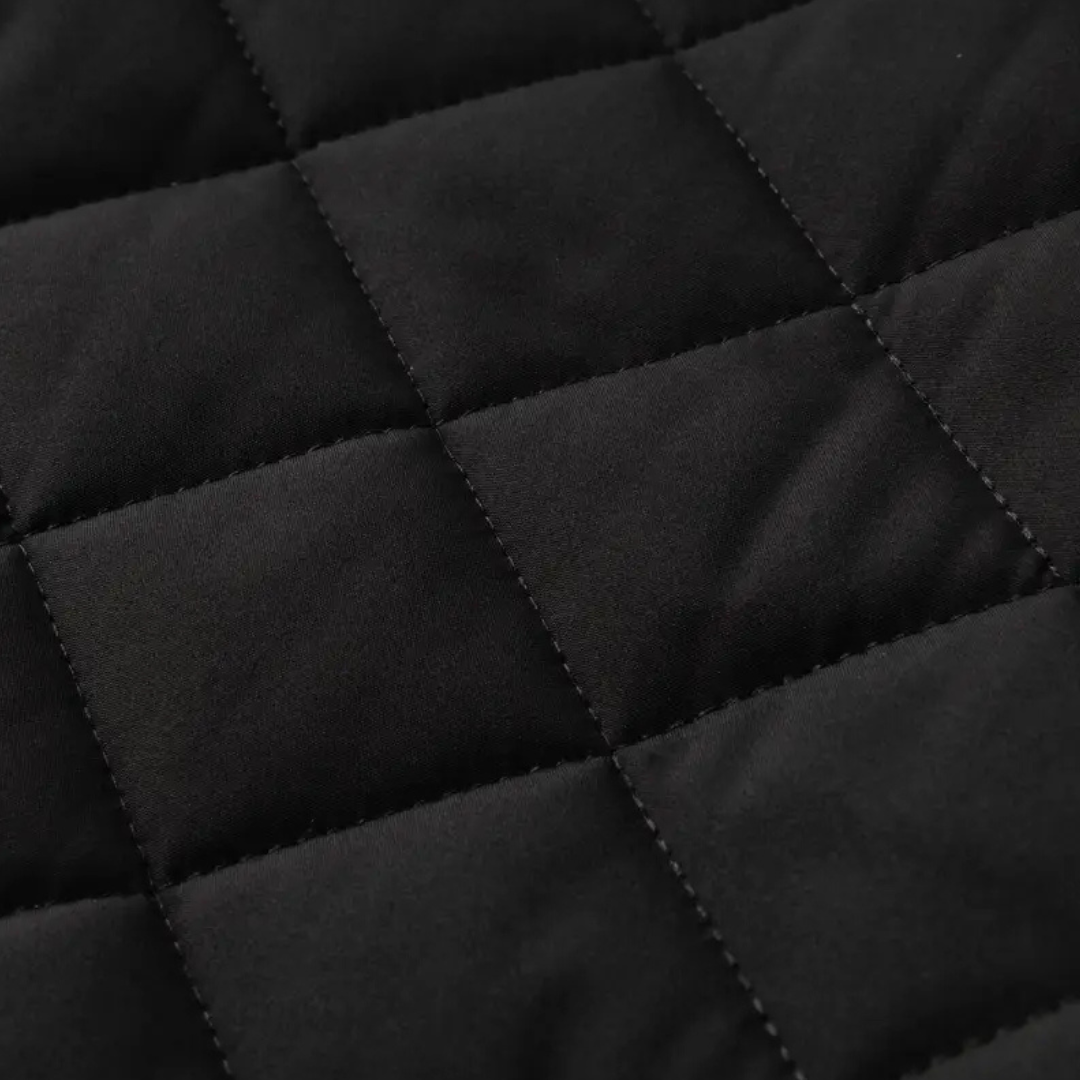 Close-up of the black diamond quilting and stitching on the jacket — Aveloire