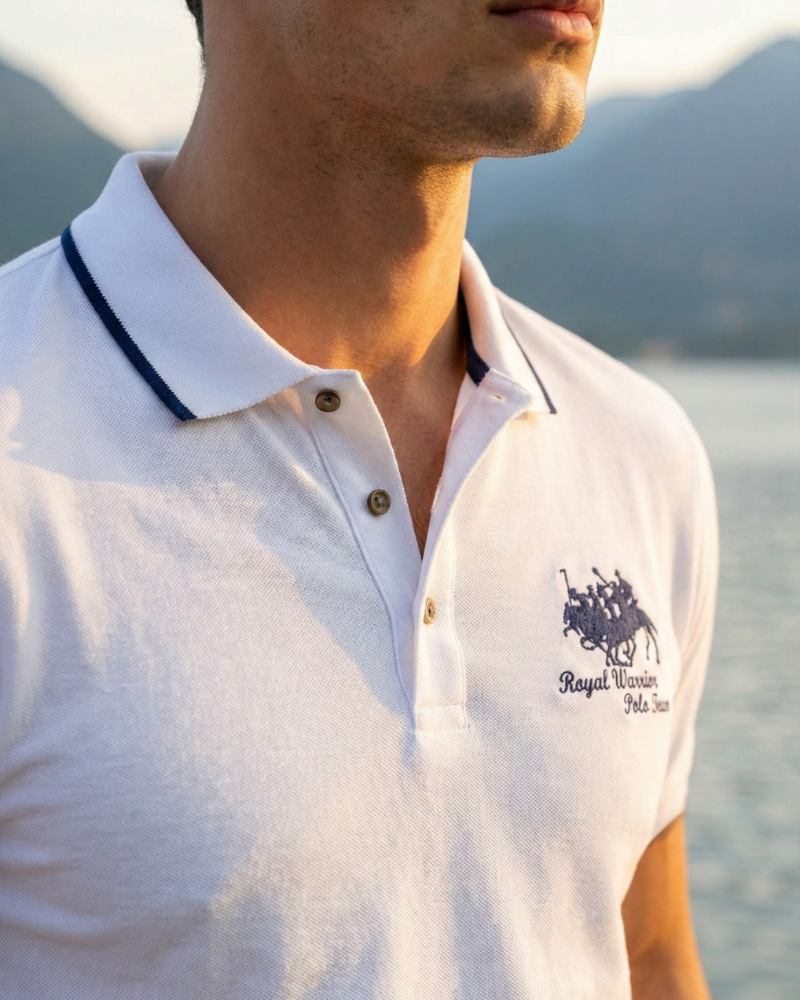 Close-up of men’s white embroidered polo shirt collar and logo detail