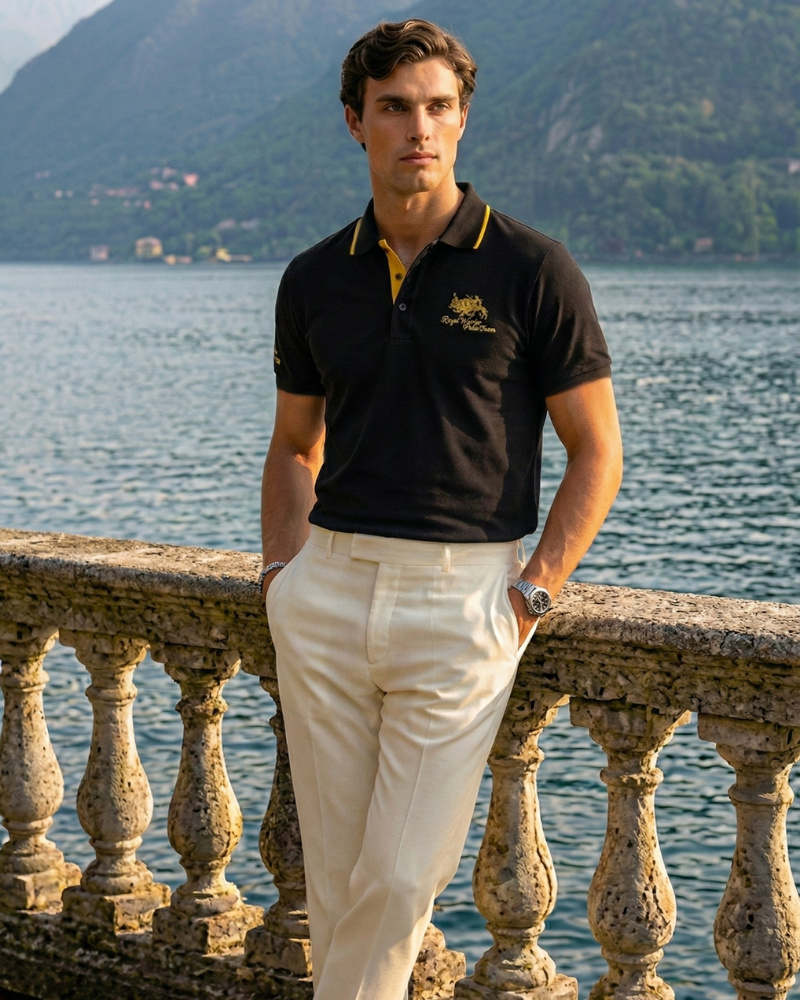 Men’s black short sleeve embroidered polo shirt styled with light trousers