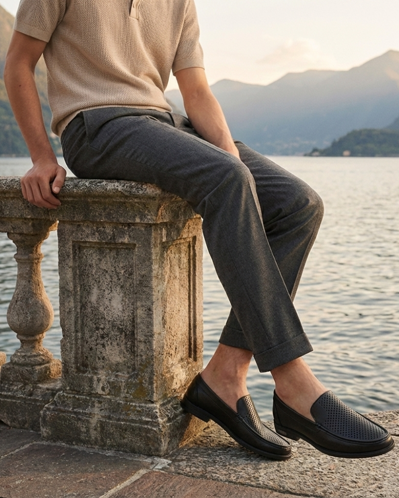 Men’s black leather loafers styled casually with slim trousers
