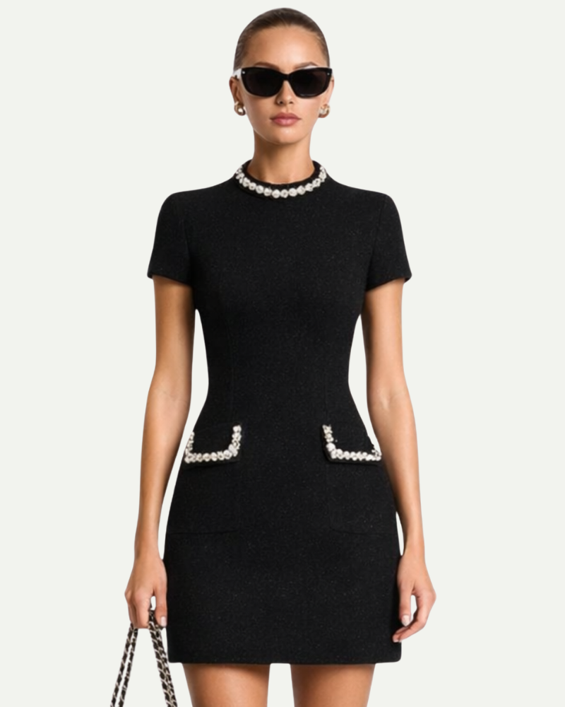 Female model wearing black tweed mini dress embellished pockets short sleeve fitted look