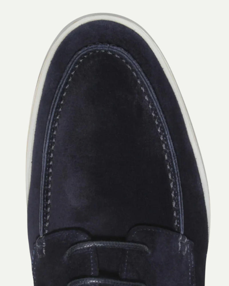 Close-up of navy faux leather loafer toe and stitching detail