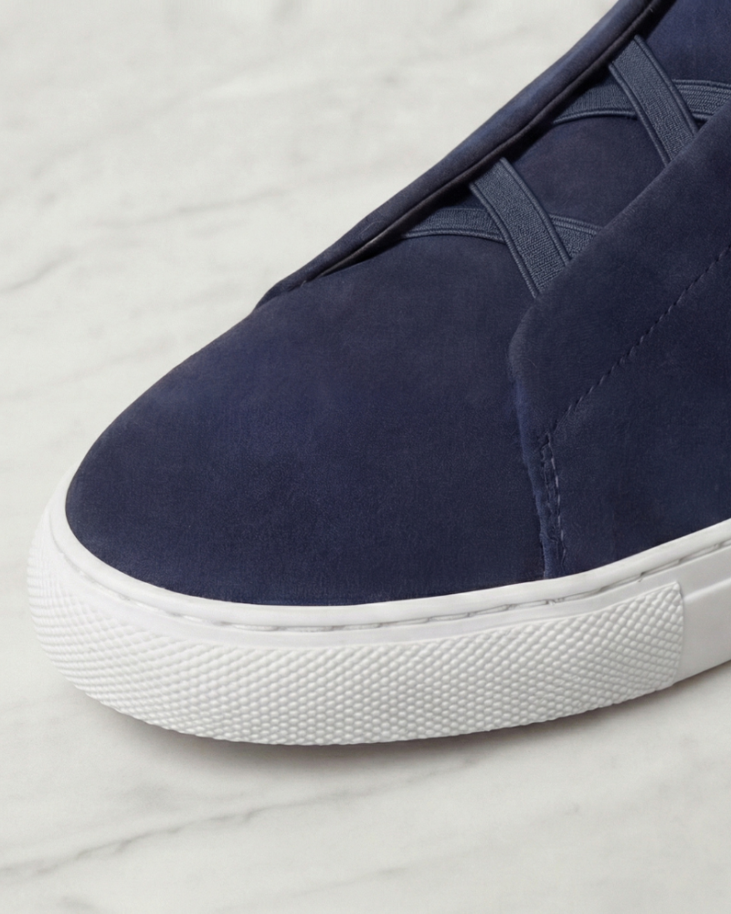 Close up men navy suede sneakers toe detail white rubber sole texture