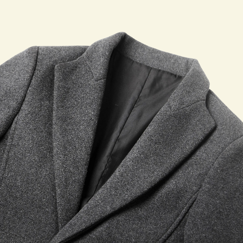 Close-up of the stand collar and smooth fabric on the gray overcoat — Aveloire