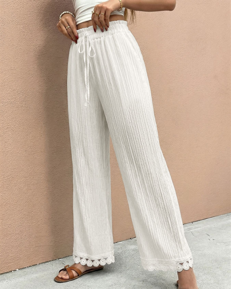model wearing white wide leg trousers high waist drawstring side pose wide leg fit