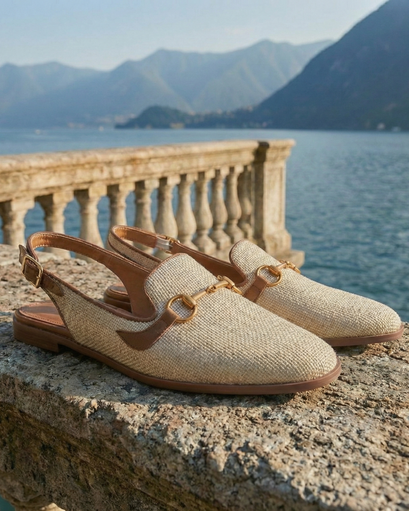 Women’s beige slingback flats with gold horsebit detail displayed on terrace