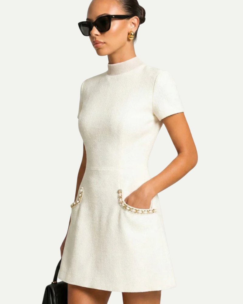 Female model wearing white tweed mini dress side view fitted silhouette