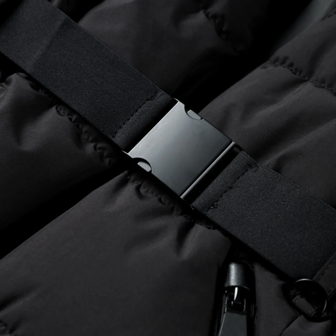 Close-up of the waist belt buckle on the black puffer coat — Aveloire