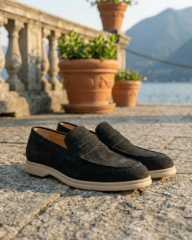 Men’s black leather slip-on loafers displayed on terrace
