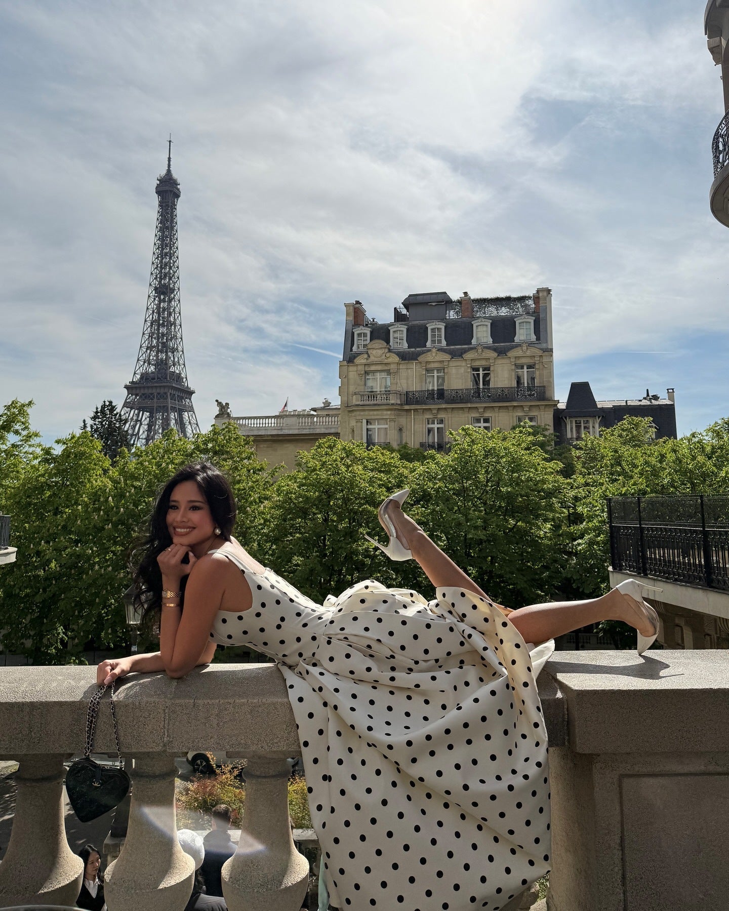 White polka dot midi dress women sitting pose flowing elegant summer dress