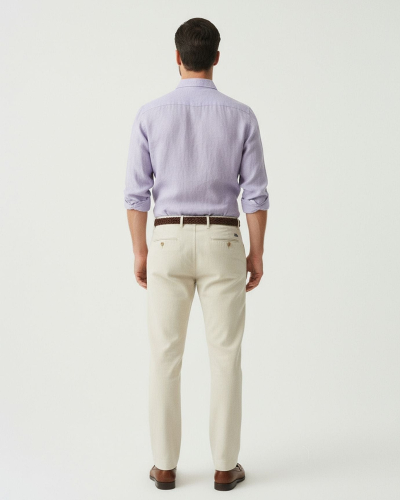 Male model wearing a light purple linen button-up shirt, back view
