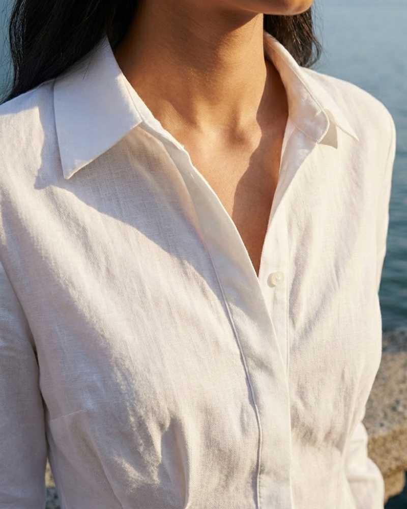 Close-up of white long sleeve shirt dress collar and button front detail