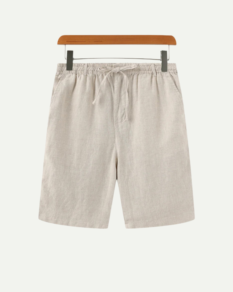 Beige shorts on a hanger against a white background