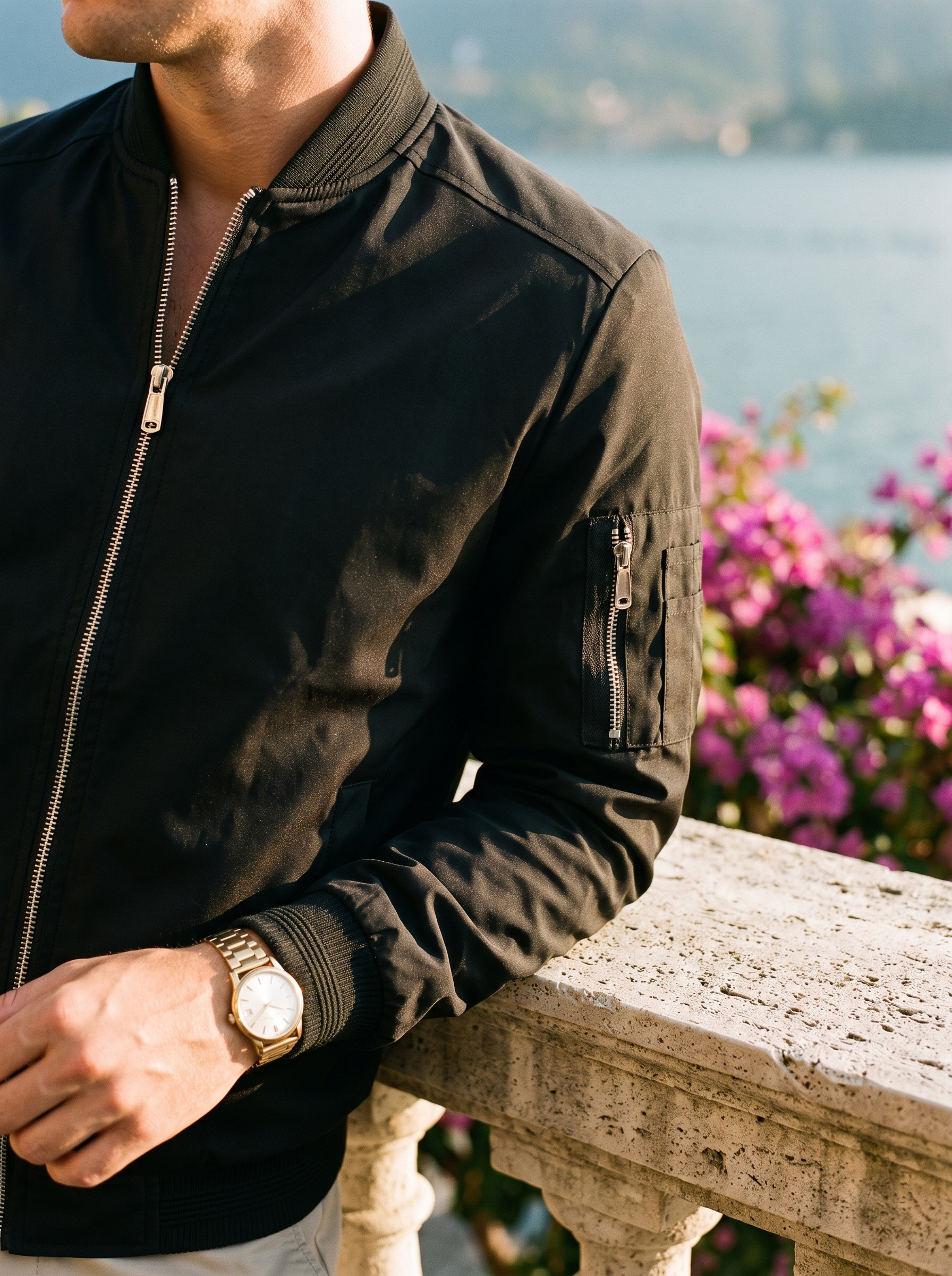 Black bomber jacket collar, zip and sleeve pocket detail with gold watch, Lake Como, old money style — Aveloire