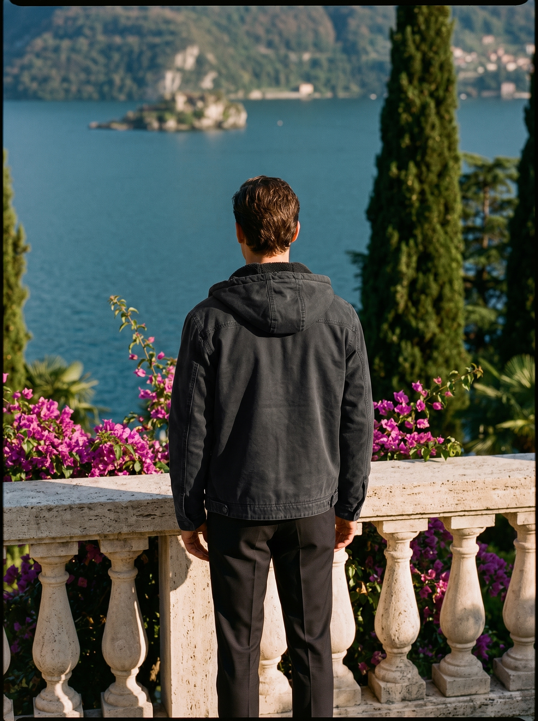 Man wearing a black hooded canvas jacket, full-length back view on a Lake Como terrace, old money style — Aveloire