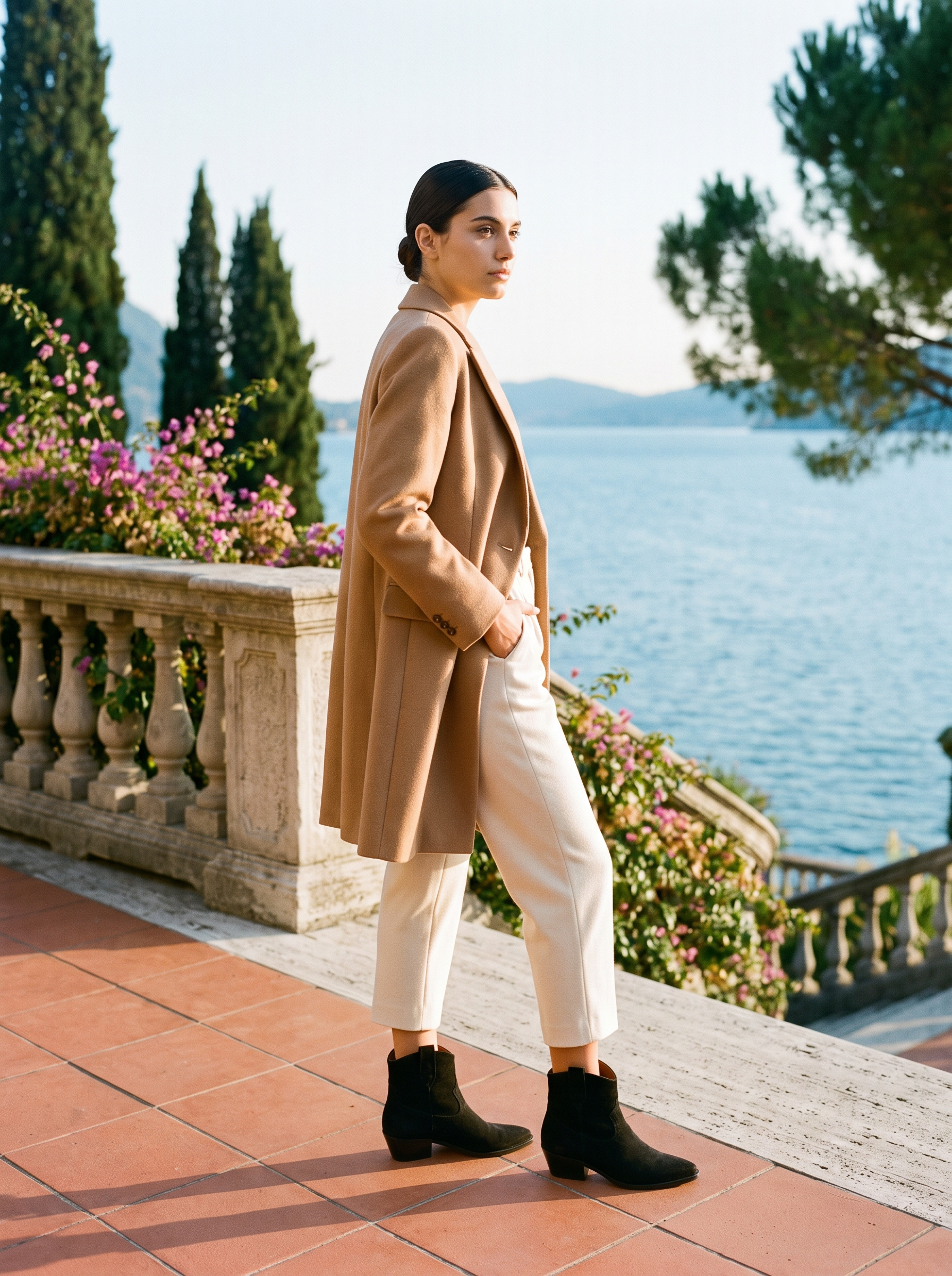 Black slouch western ankle boots styled with cream trousers and camel coat
