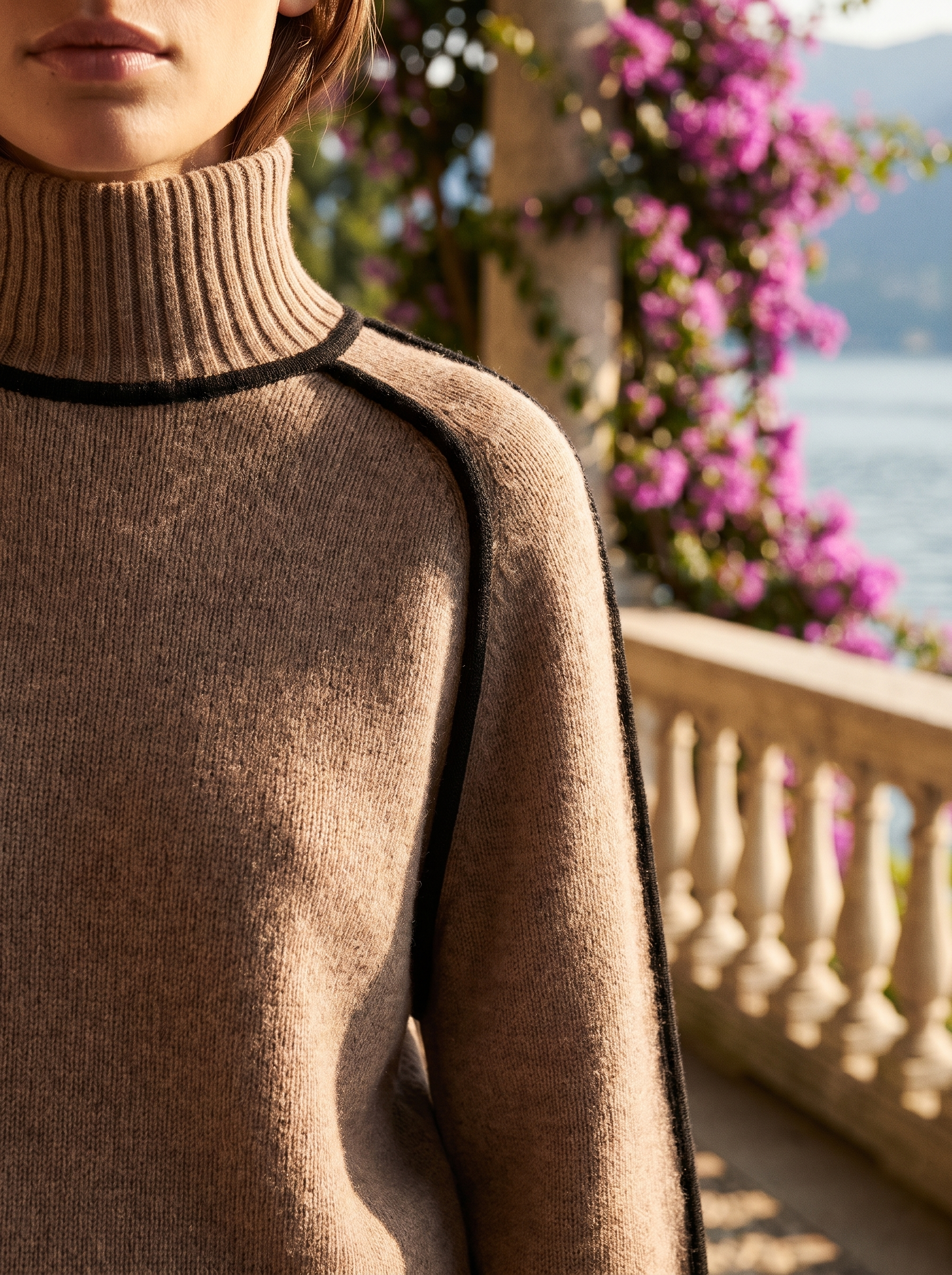 Close-up of the roll-neck and black contrast trim of a brown turtleneck jumper — Aveloire