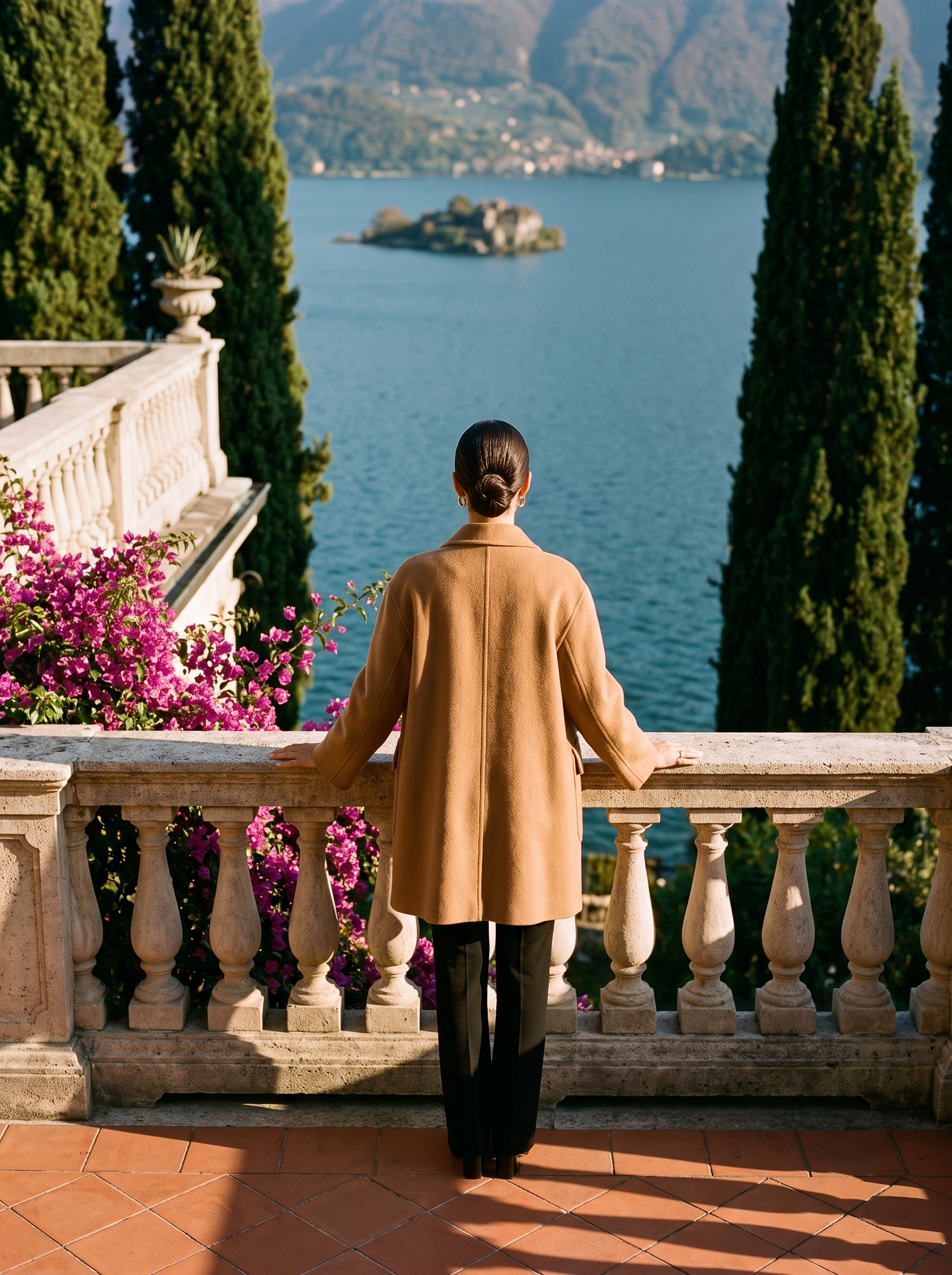 Back view of a camel double-breasted wool coat on a Lake Como terrace — Aveloire