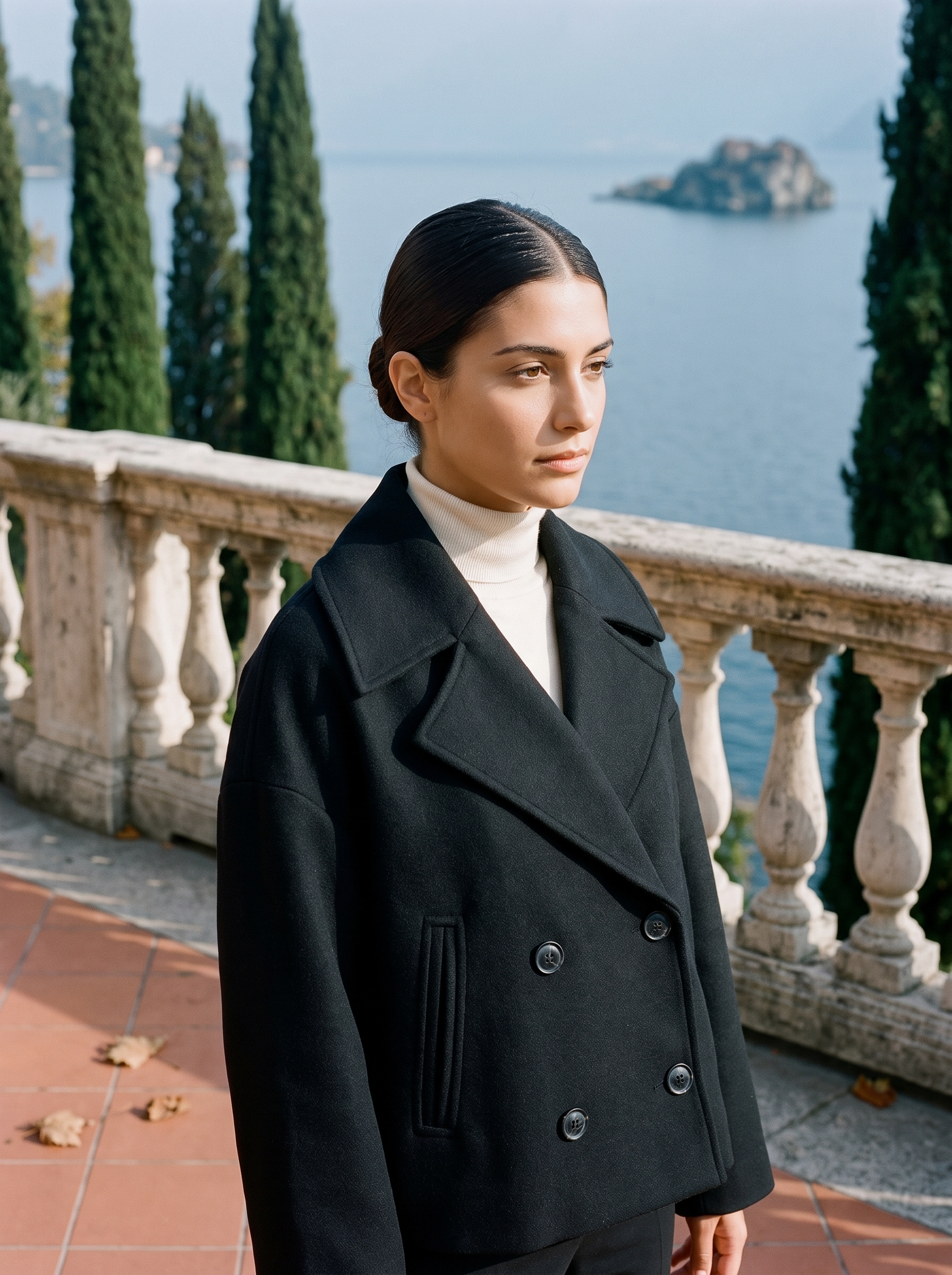 Black cropped peacoat for women, worn on a Lake Como terrace — Aveloire