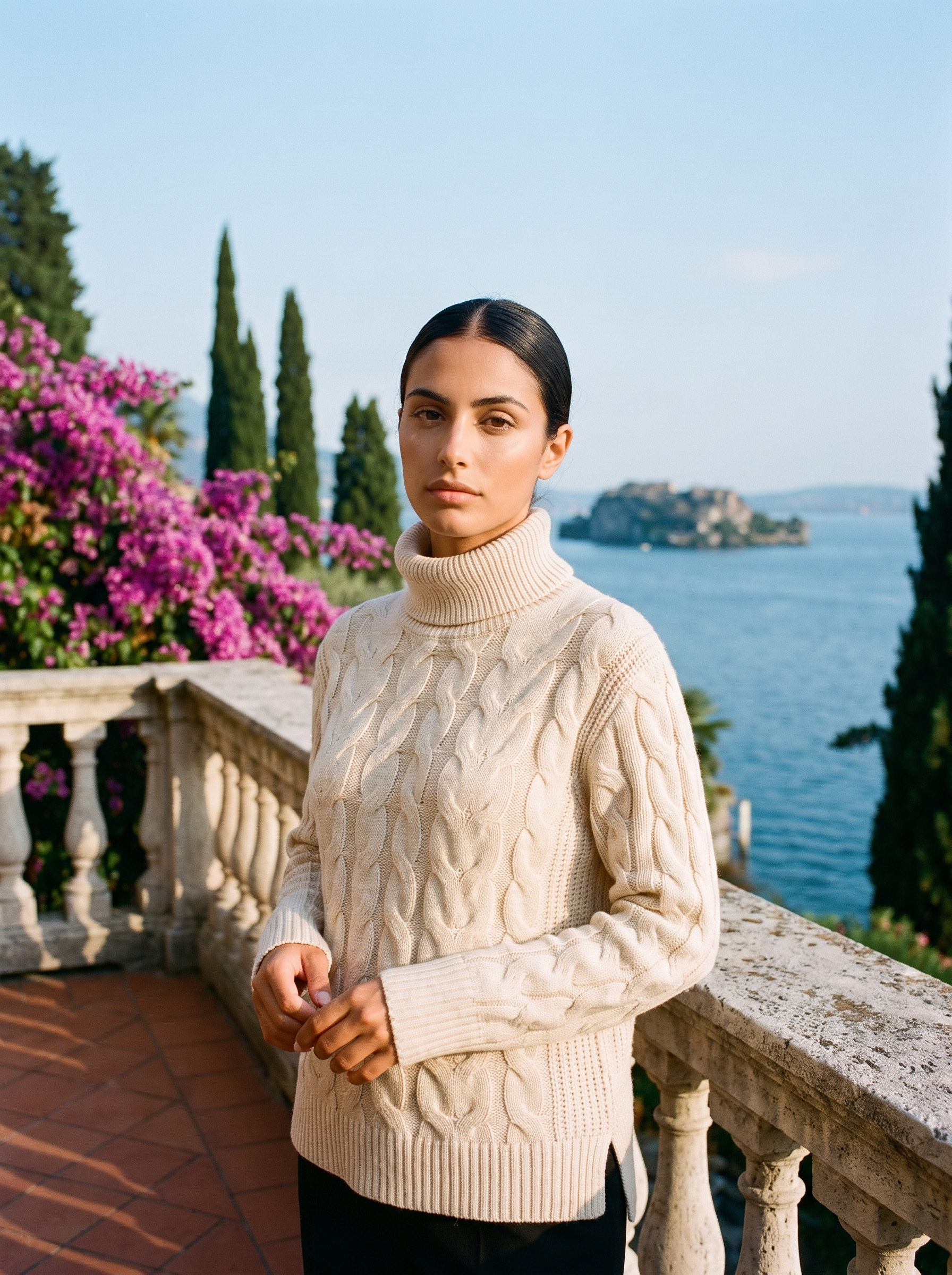 Woman wearing a cream cable-knit turtleneck sweater on a Lake Como terrace, old money style — Aveloire