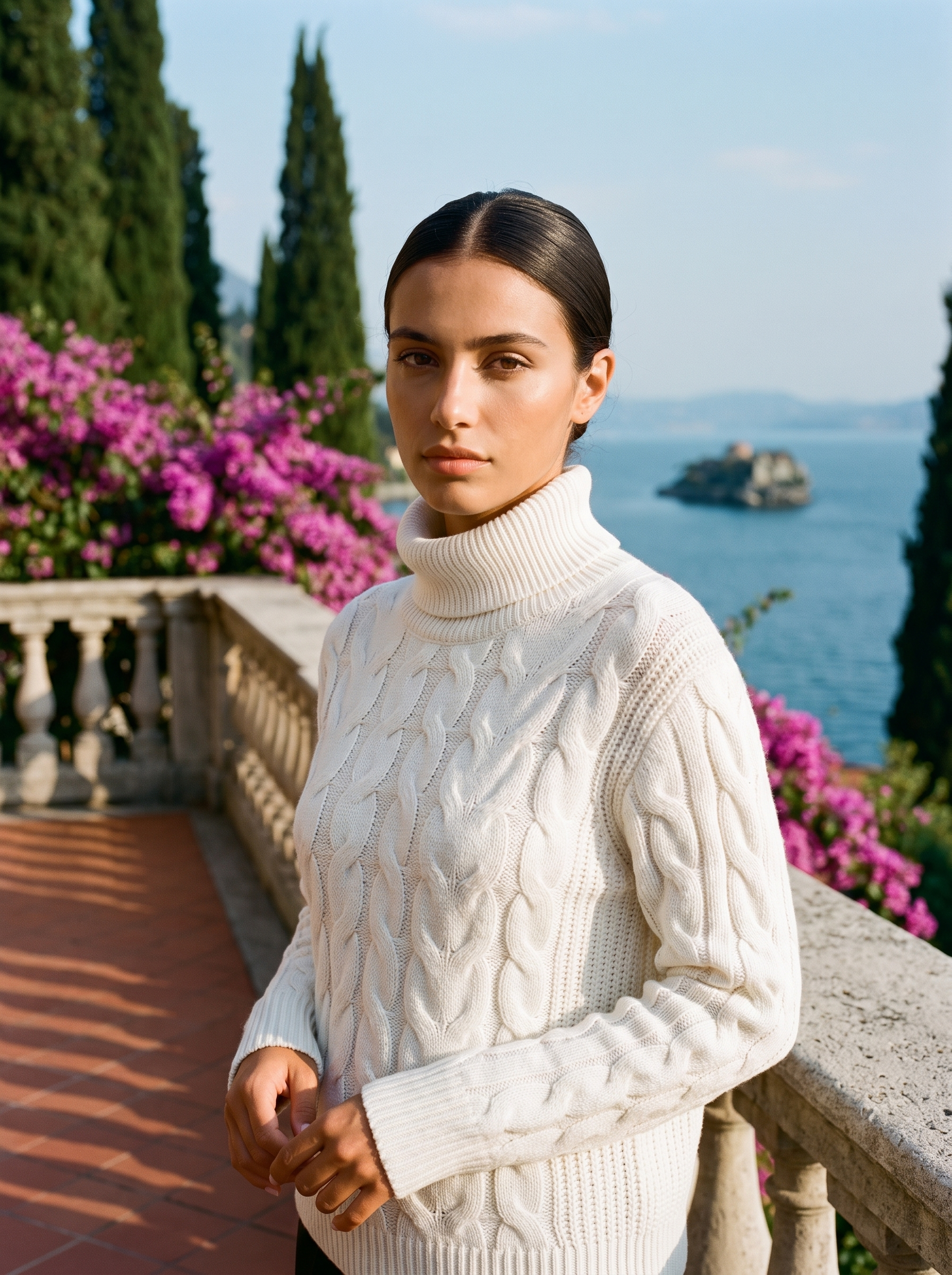 Woman wearing a white cable-knit turtleneck sweater on a Lake Como terrace — Aveloire