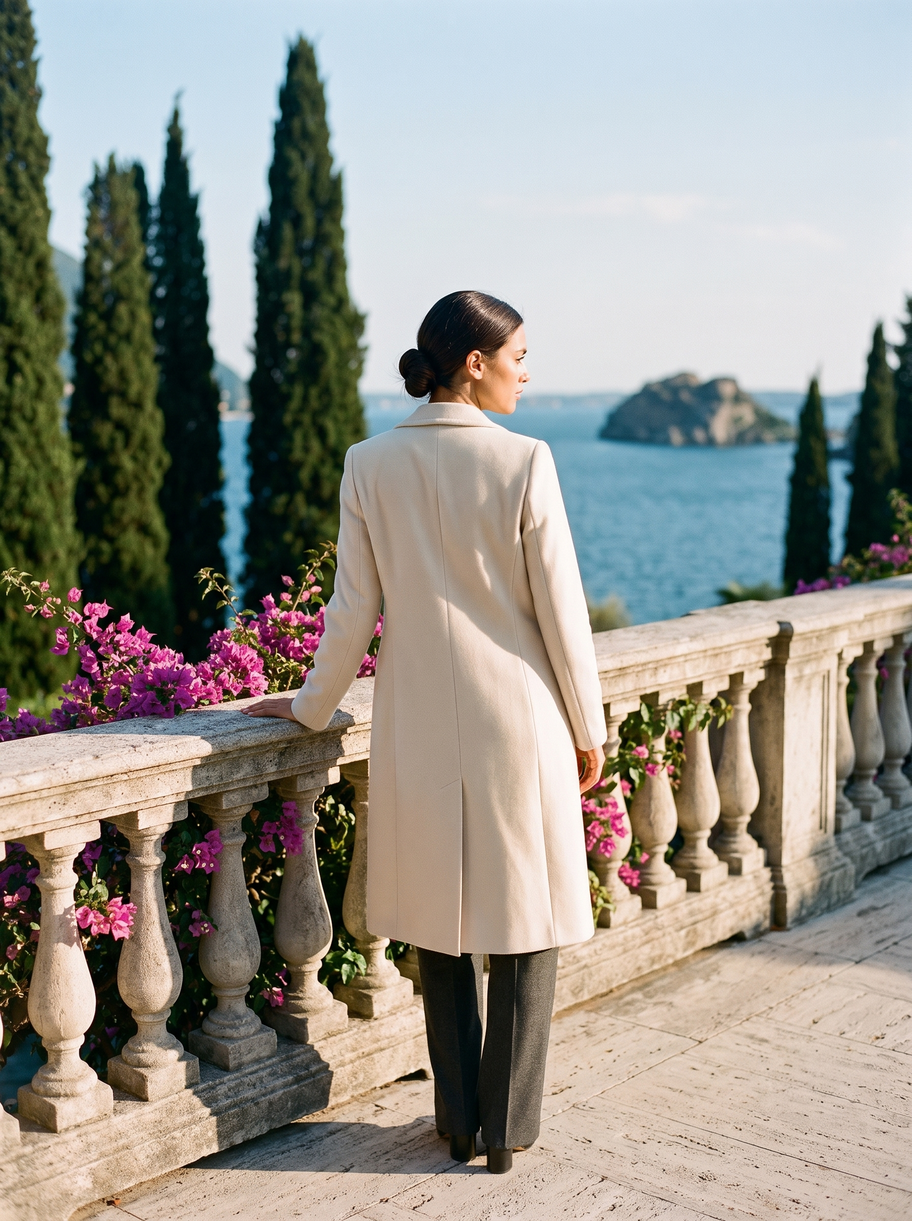 Back view of a cream longline wool coat on a Lake Como terrace, old money style — Aveloire