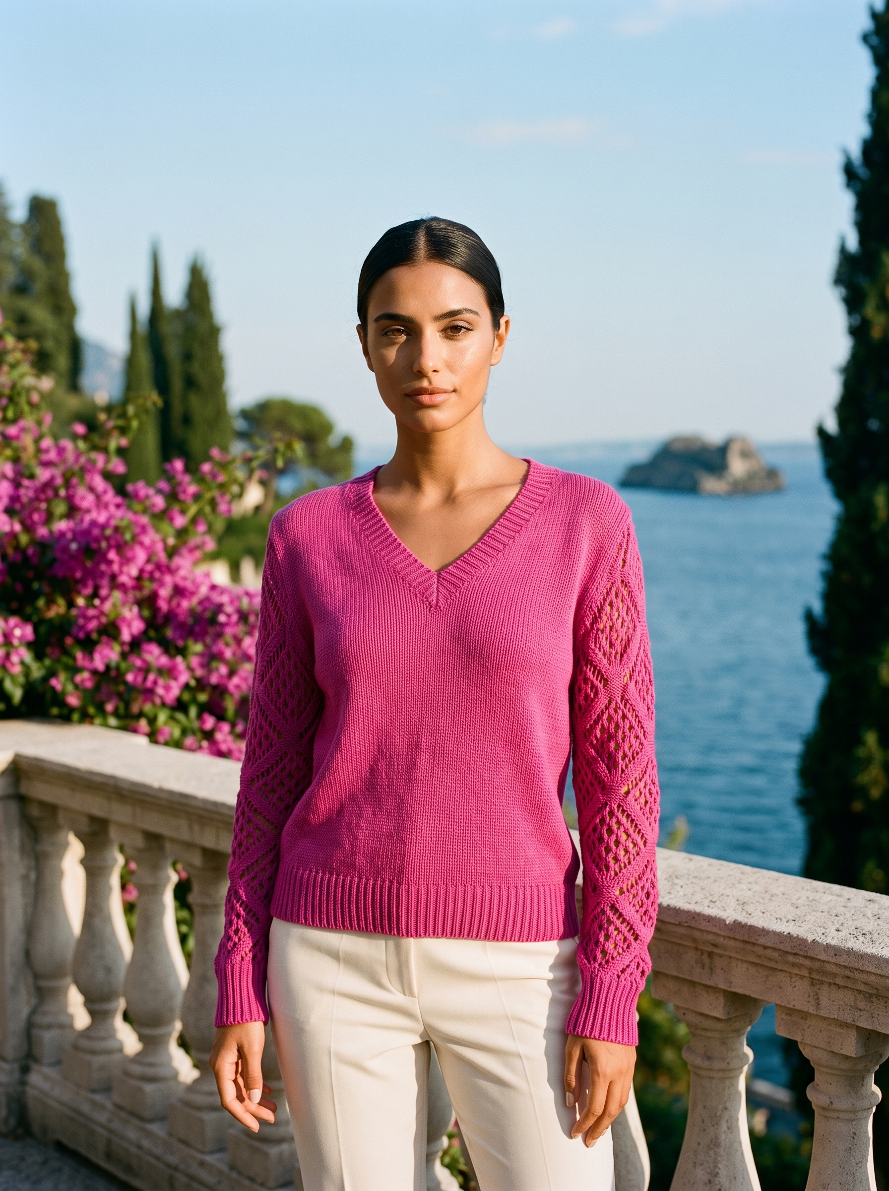 Woman wearing a magenta pink V-neck knit jumper on a Lake Como terrace, old money style — Aveloire