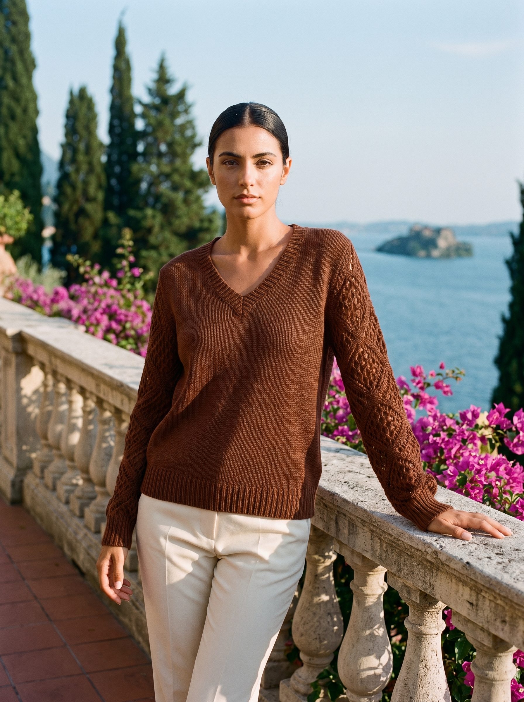 Woman wearing a chestnut brown V-neck knit jumper on a Lake Como terrace, old money style — Aveloire