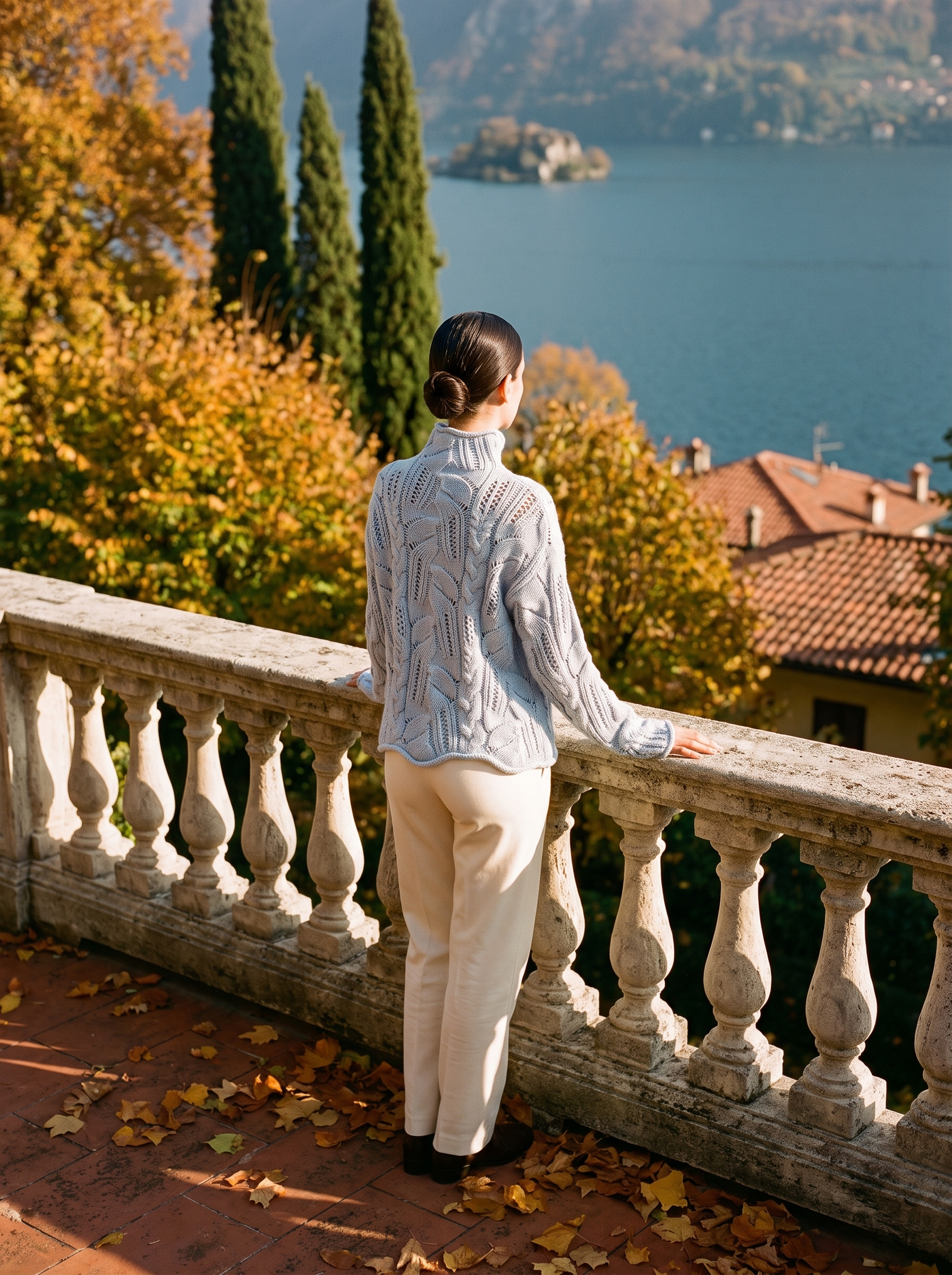 Light blue pointelle turtleneck sweater, back view showing the openwork cable panels — Aveloire