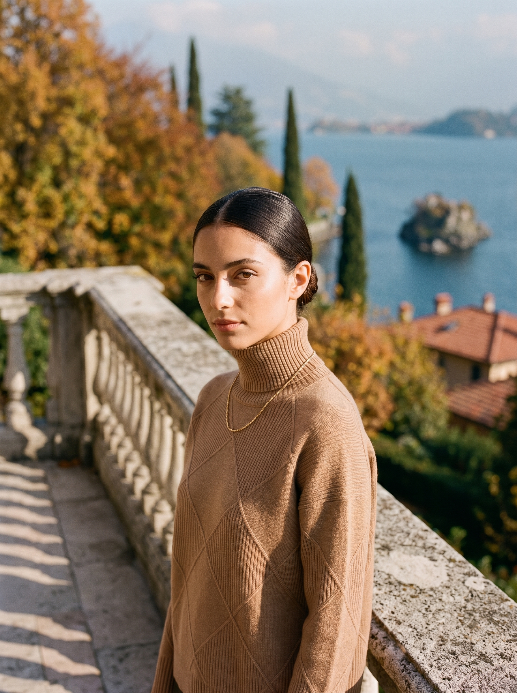 Woman wearing a brown cable knit turtleneck sweater by Lake Como — Aveloire