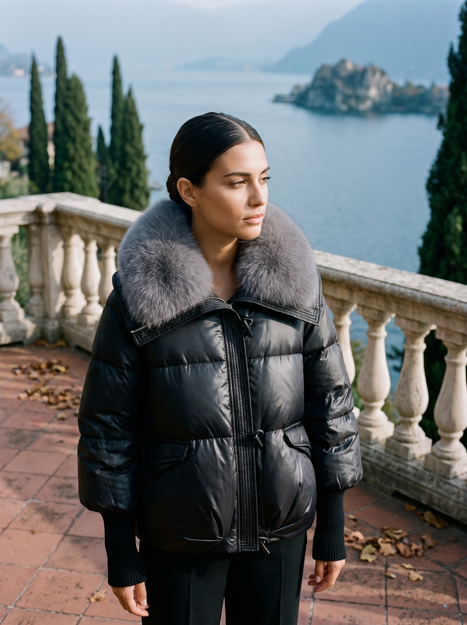 Black faux fur collar puffer jacket for women, worn on a Lake Como terrace — Aveloire