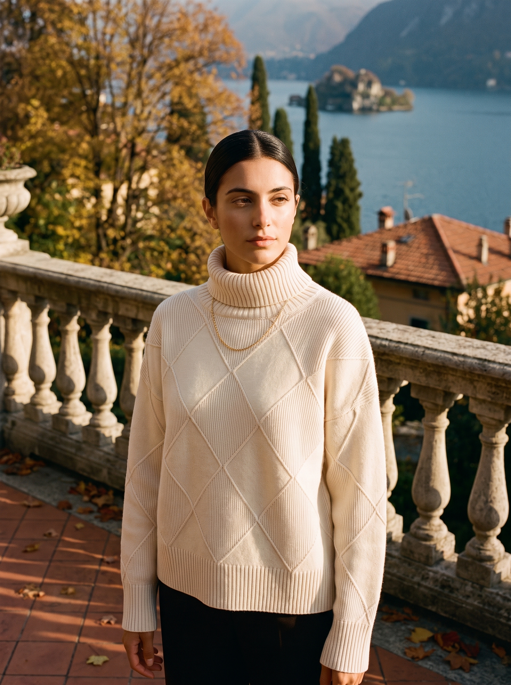 Woman wearing a cream cable knit turtleneck sweater by Lake Como — Aveloire