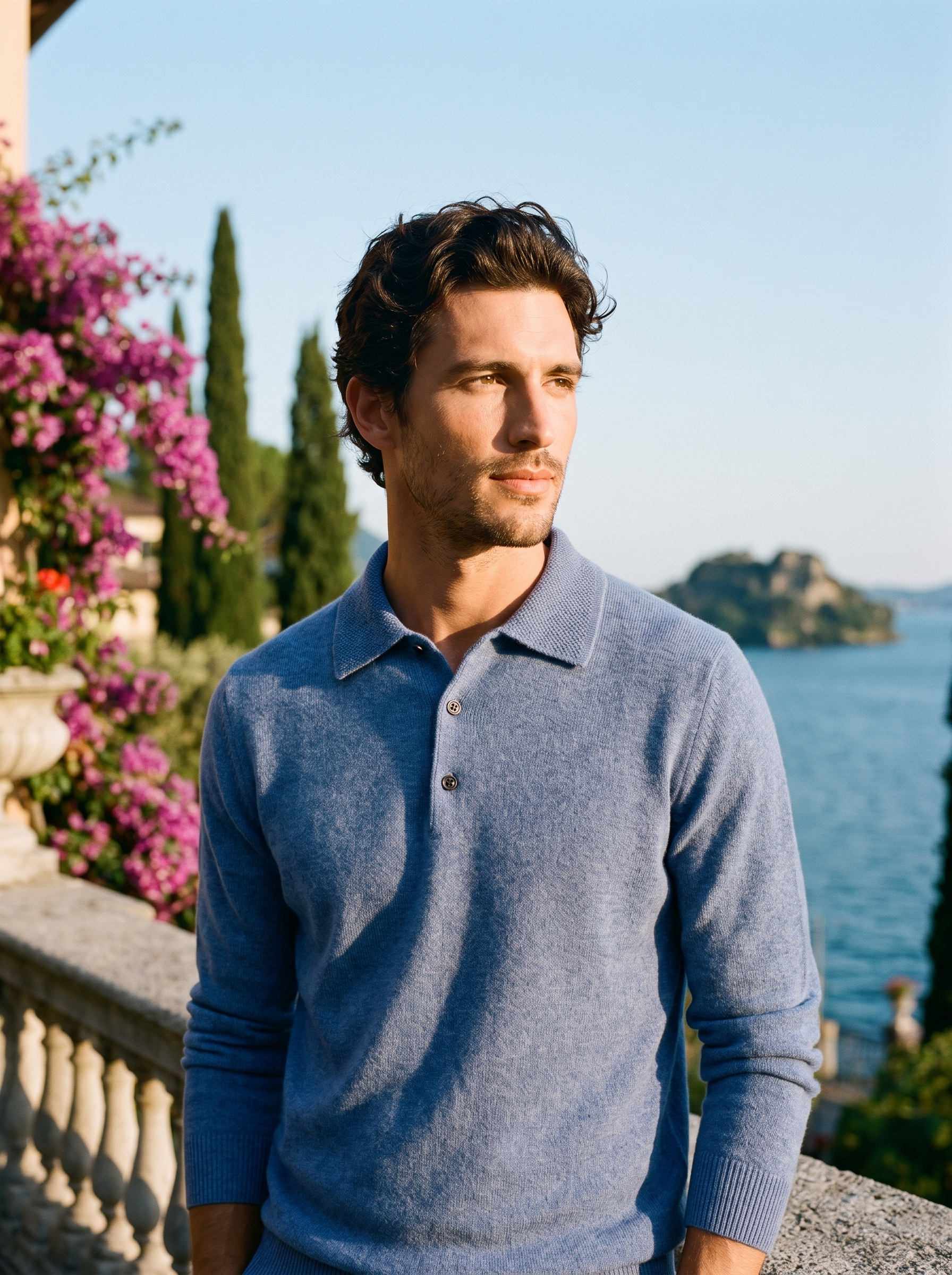 Man wearing a blue wool knit polo sweater on a terrace overlooking Lake Como, old money style — Aveloire