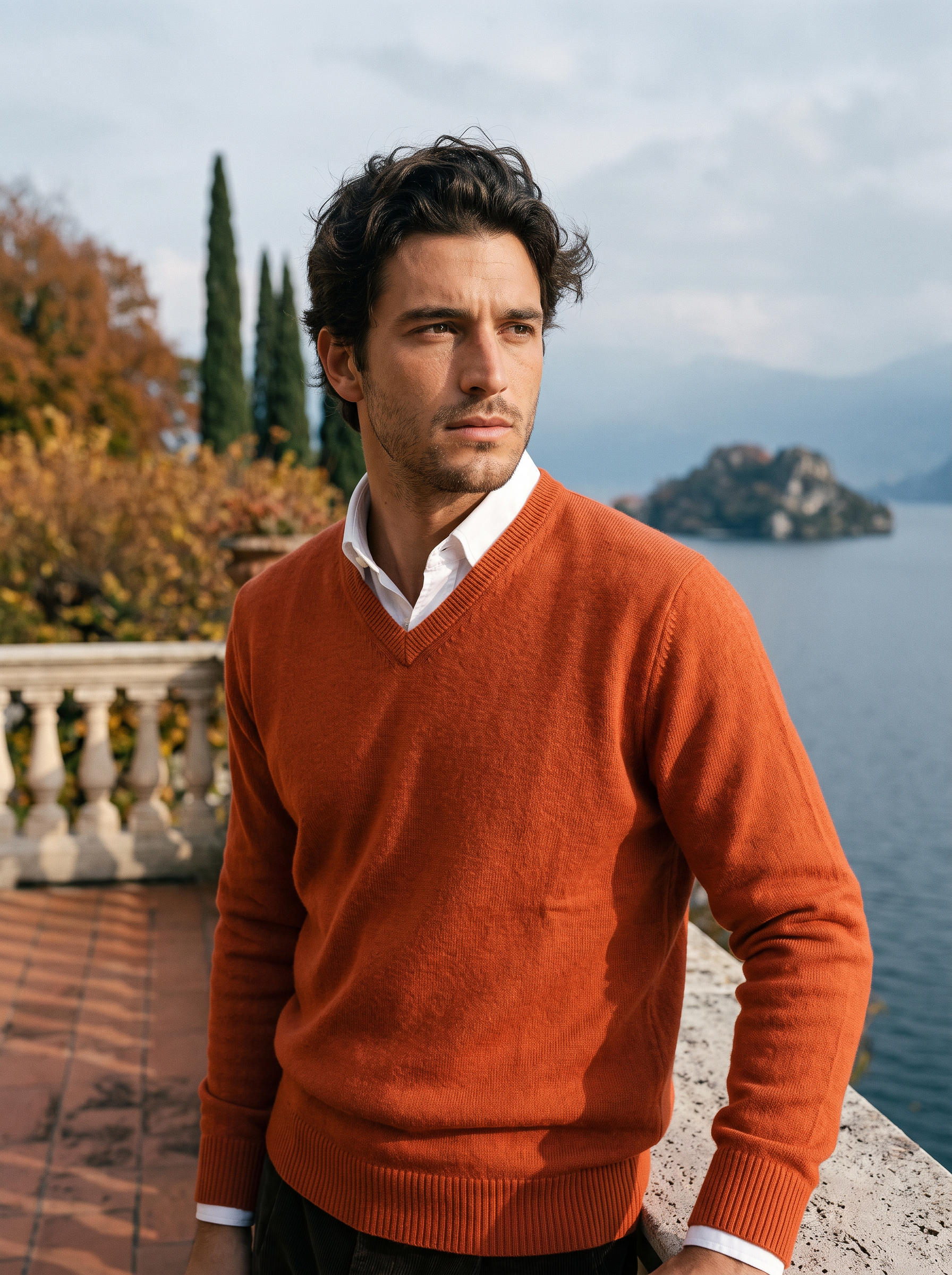 Rust wool v neck sweater for men, worn on a Lake Como terrace — Aveloire