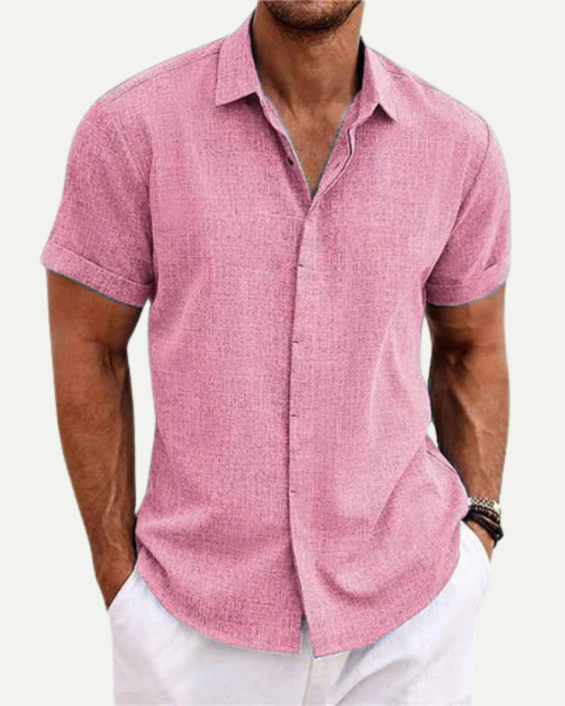 Man wearing a pink short-sleeve shirt with a white background