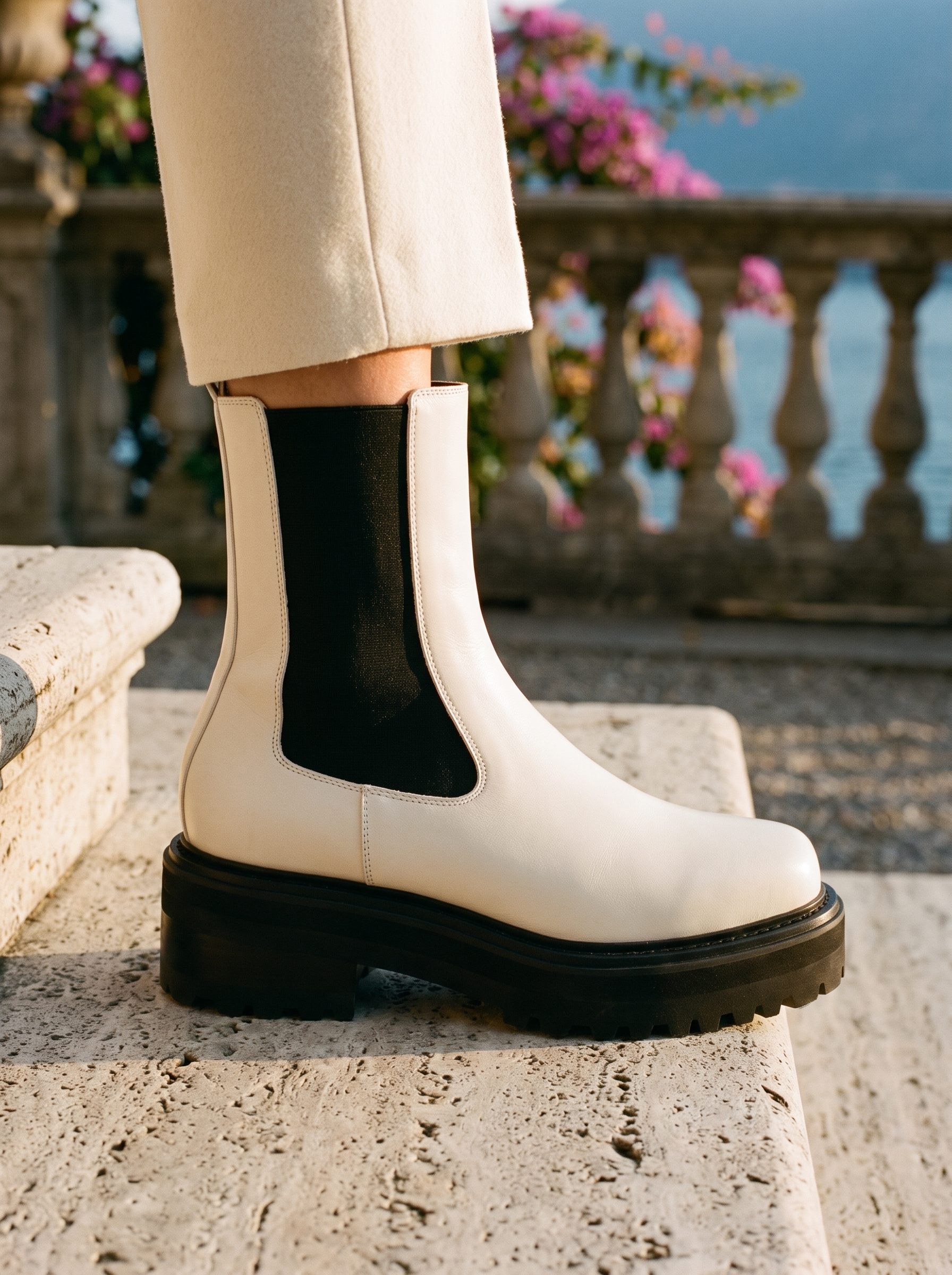 Close-up detail of the charcoal elastic gore and treaded platform on white Chelsea boots — Aveloire
