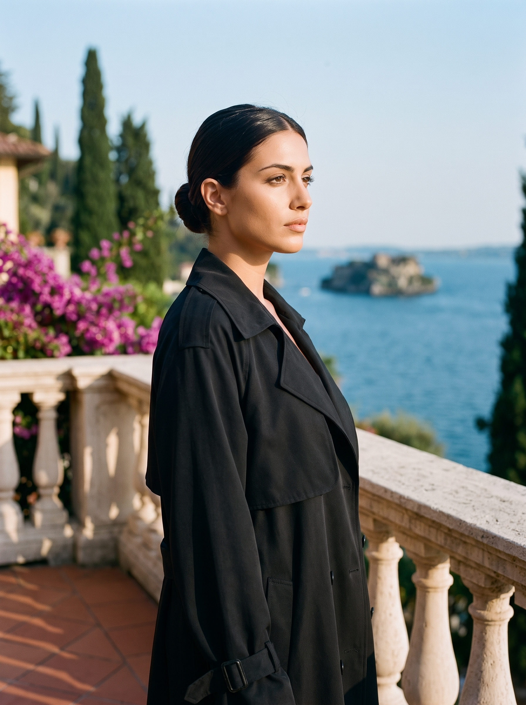 Woman wearing black lightweight trench coat on a Lake Como terrace — Aveloire