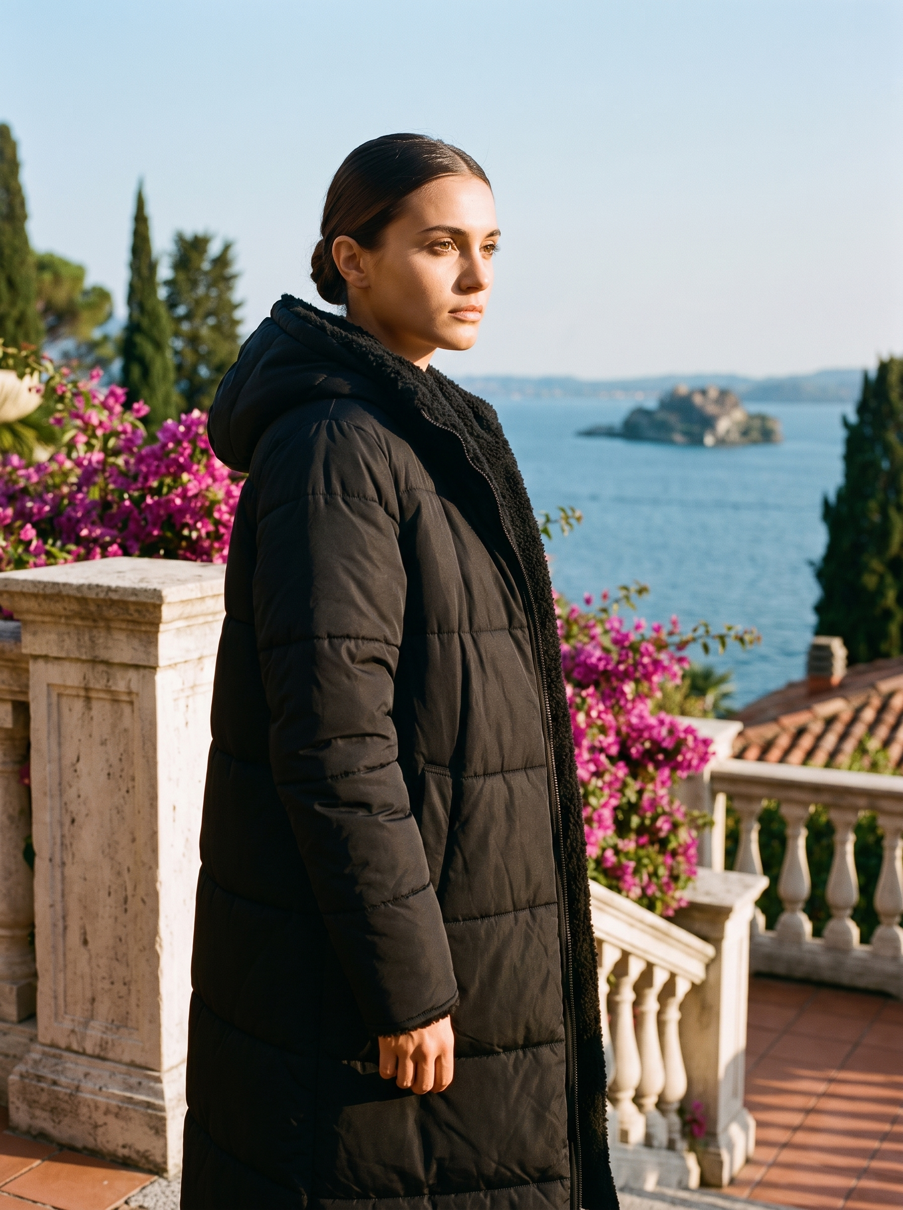 Woman wearing black puffer coat on a Lake Como terrace — Aveloire