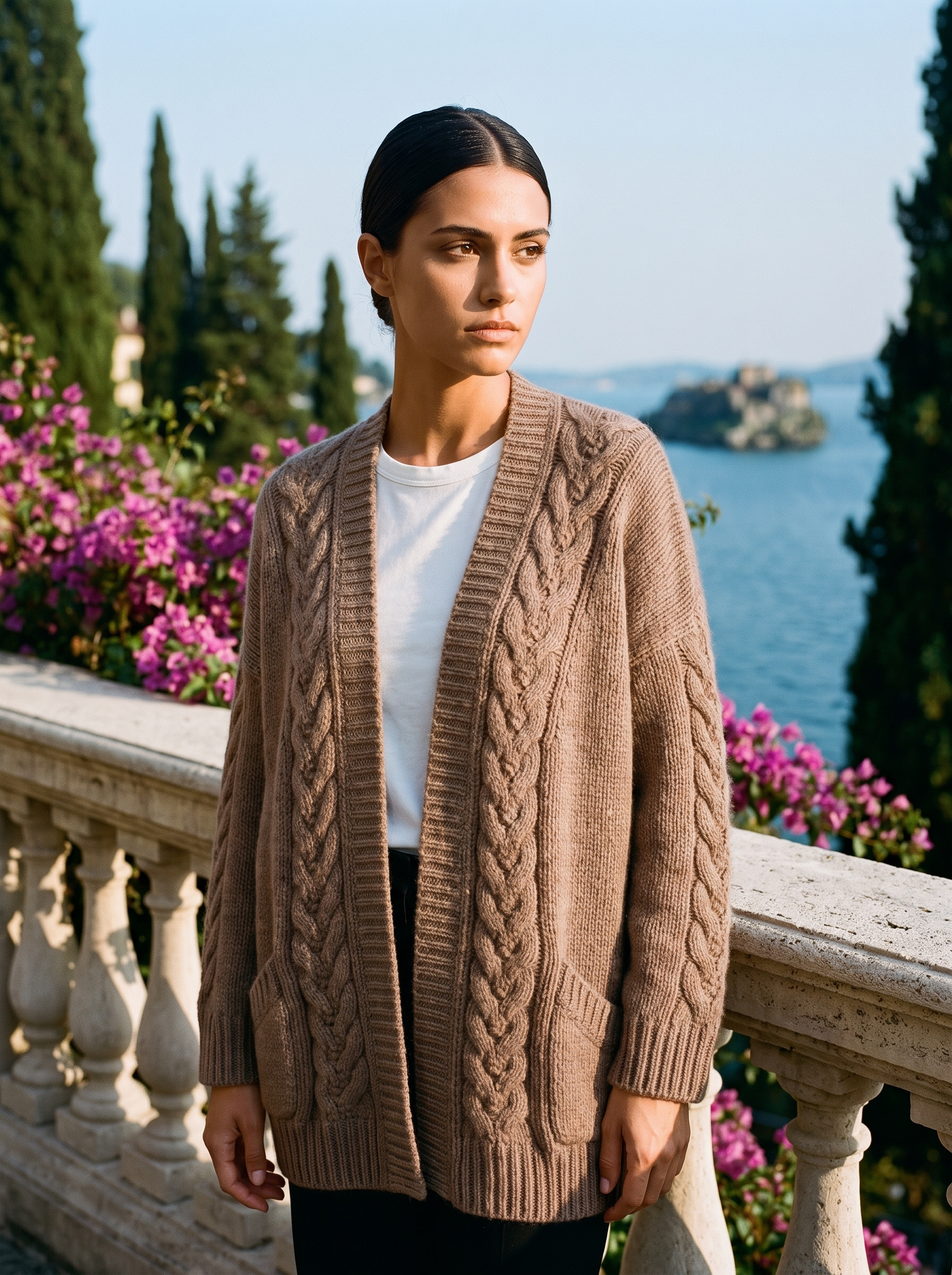 Woman wearing a brown open-front cardigan on a terrace overlooking Lake Como, old money style — Aveloire