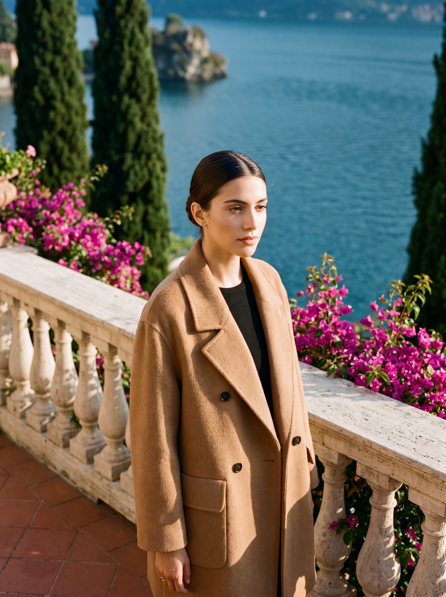 Woman wearing a camel double-breasted wool coat on a Lake Como terrace — Aveloire