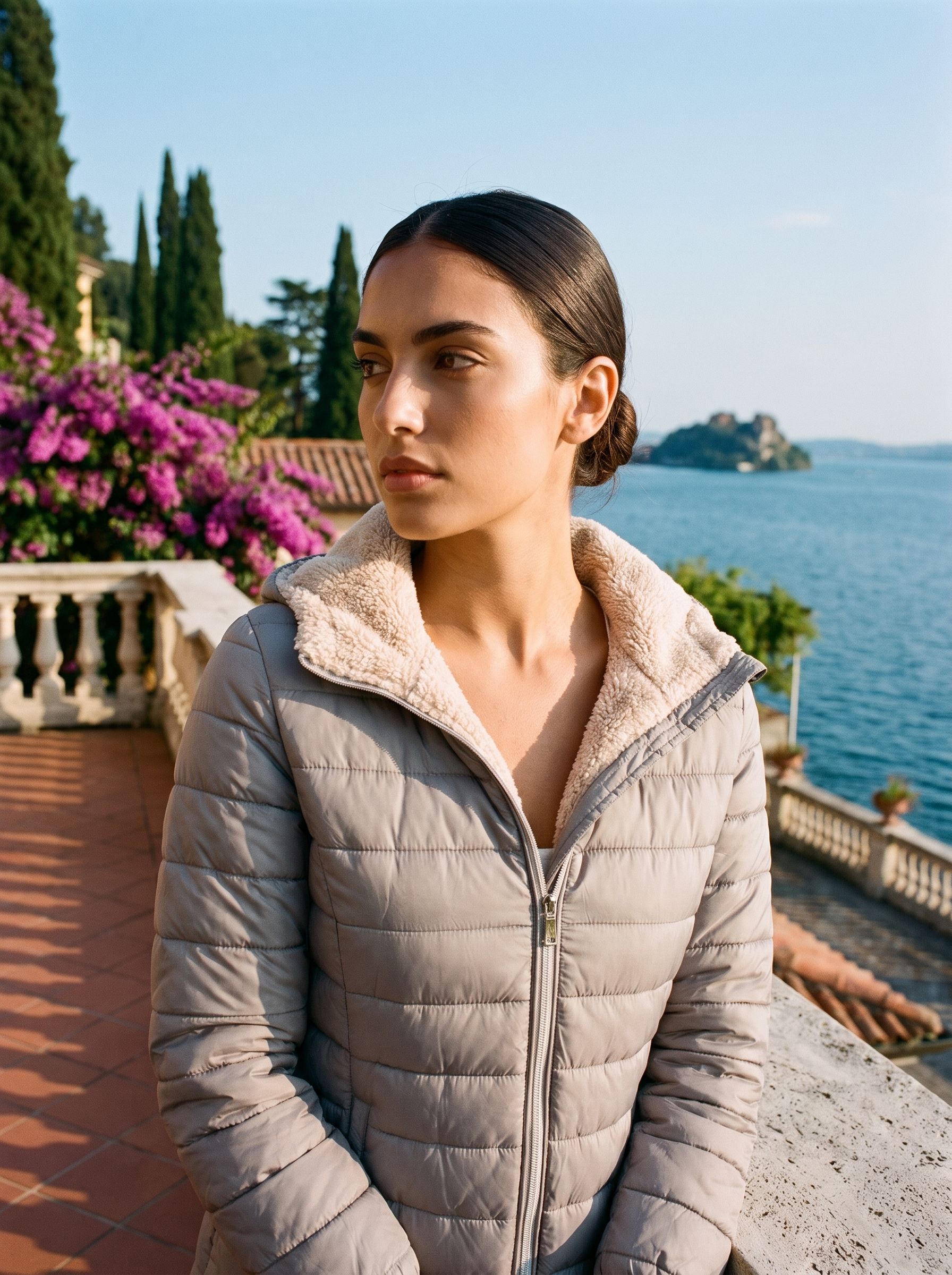 Woman wearing grey sherpa winter coat on a Lake Como terrace — Aveloire