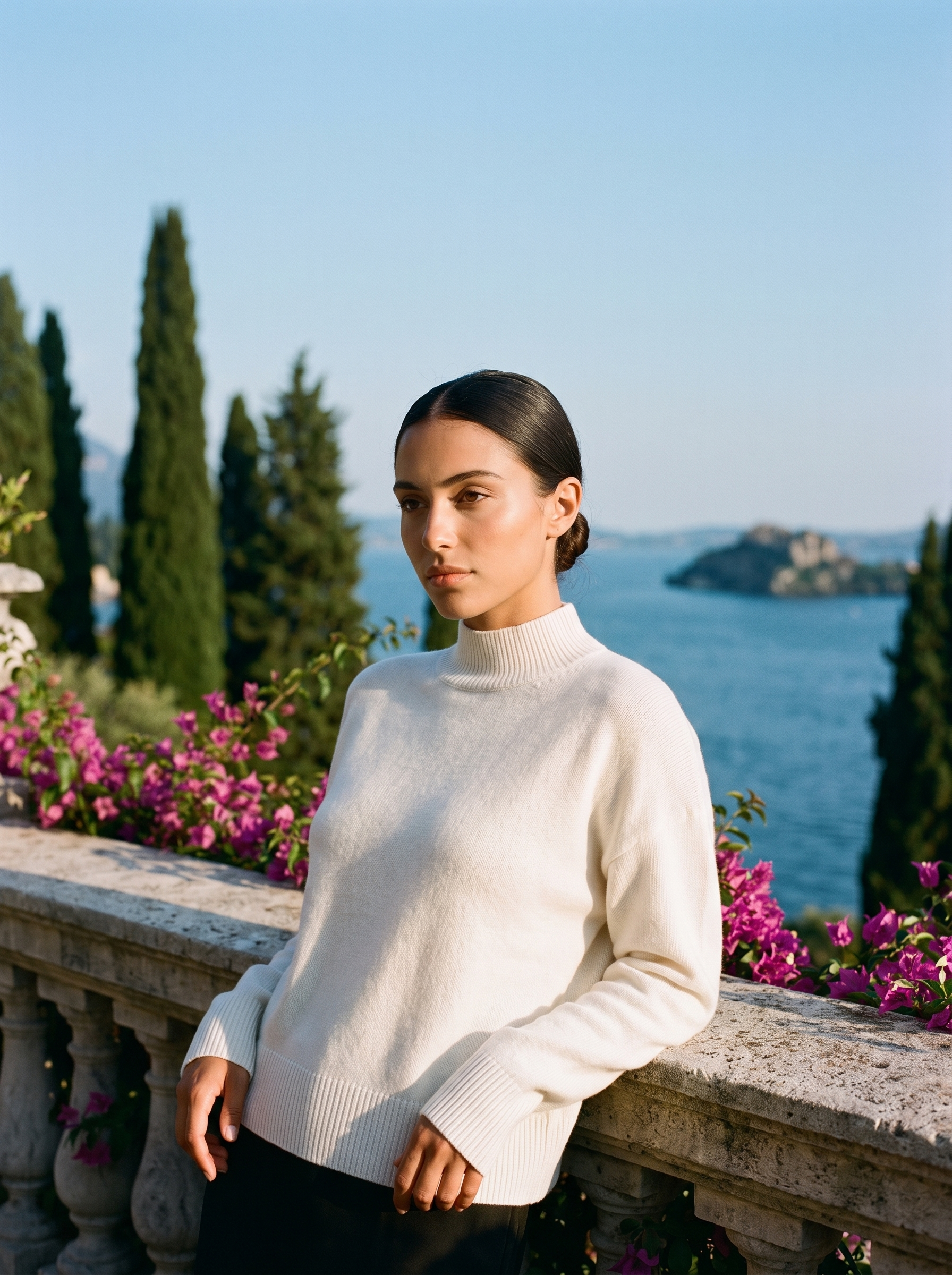 Woman wearing an ivory mock-neck jumper on a terrace overlooking Lake Como, old money style — Aveloire