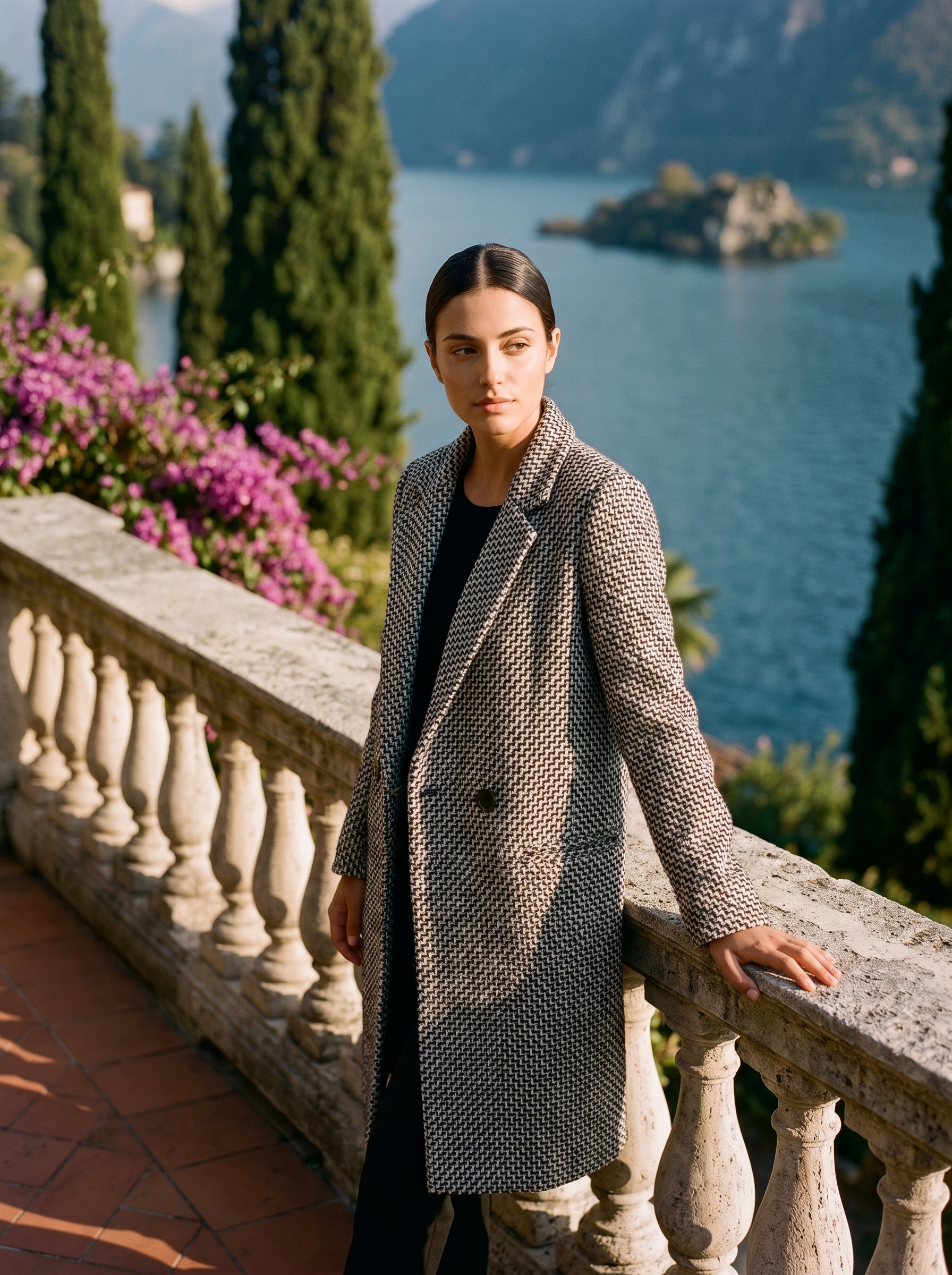 Woman wearing a black-and-white tweed wool coat on a Lake Como terrace — Aveloire