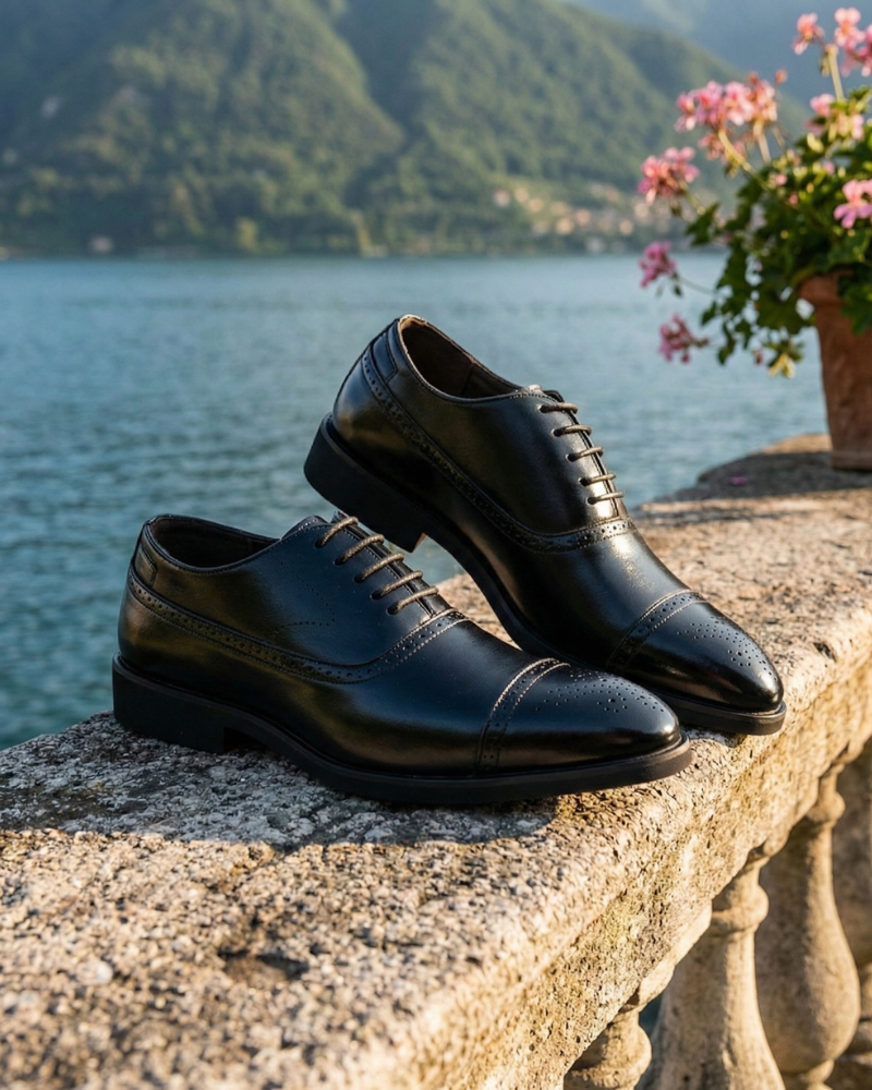 Men’s black leather lace-up dress shoes displayed on terrace