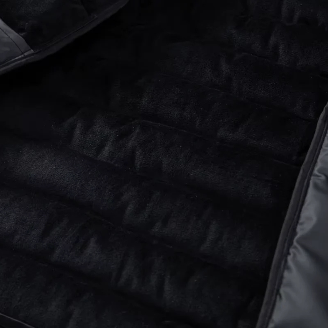 Close-up of the horizontal quilted baffles on the down puffer jacket — Aveloire