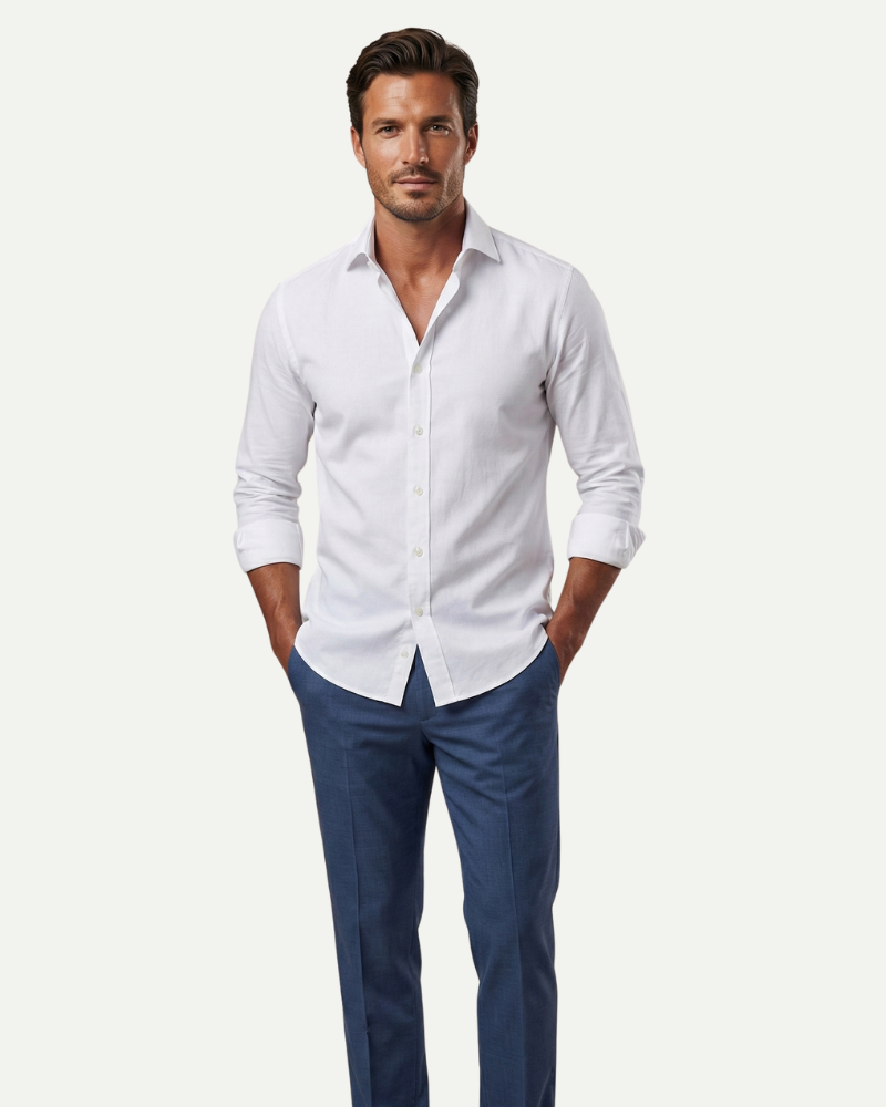 Men’s white fitted button-up dress shirt styled with dark jeans