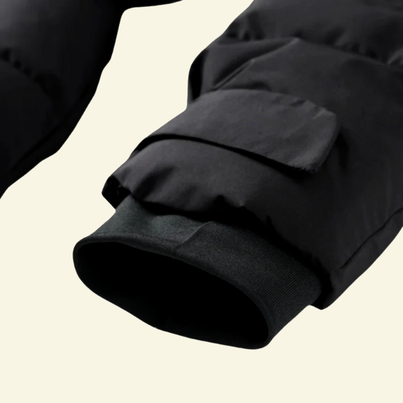 Close-up of the sleeve cuff on the black puffer coat — Aveloire