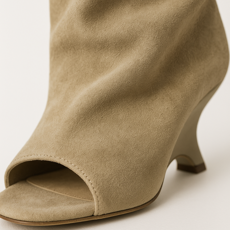 Close-up of the peep toe and sculpted wedge heel on the sand beige knee high boots — Aveloire