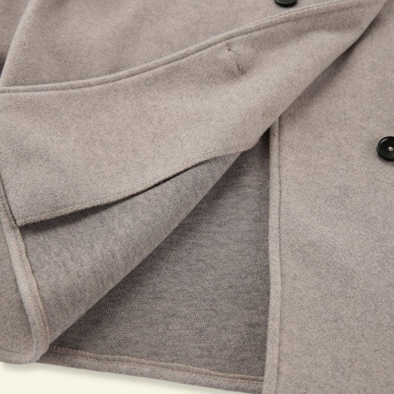Close-up of the collar edge and oatmeal wool fabric on the coat — Aveloire