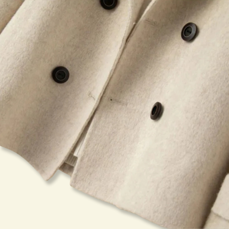 Close-up of the buttons on the front of the oatmeal ladies overcoat — Aveloire